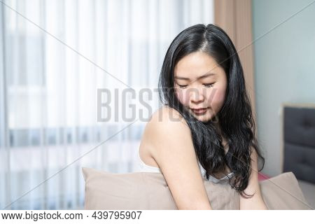 Asian Woman Is Posing With Her Sexy Shoulder On Her Bed In The Bedroom.