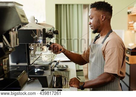 Horizontal Side View Shot Of Handsome Young African American Man Working As Barista In Small Cafe Ma