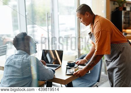 Young African American Woman Wearing Apron Working In Cafe Bringing Coffee And Delicious Dessert To 