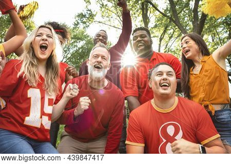 Football fans celebrating the win of their team at a tailgate party