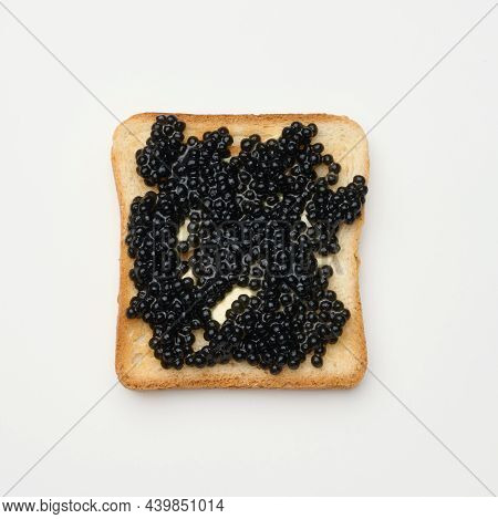 Paddlefish Caviar On A Square Slice Of White Wheat Flour. Top View On White Table