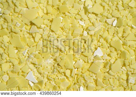 Closeup Chemical Ingredient On Laboratory Table (top View). Sodium Sulfide Flakes, A Yellow Appearan