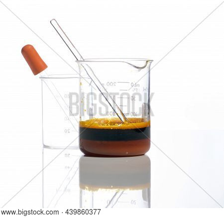 Closeup Chemical Ingredient On White Laboratory Table. Ferric Chloride Liquid With Stirring Rod In B