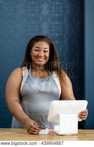 Smiling staff at a cashier