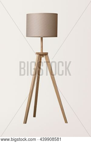Wooden tripod floor lamp with beige lamp shade