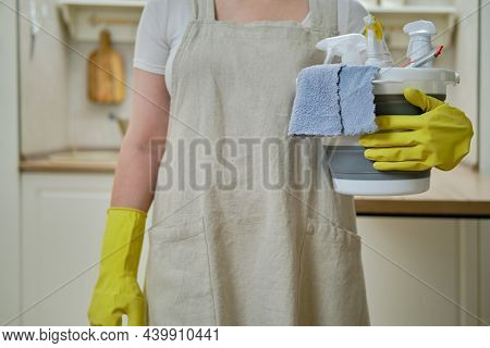 A Woman With A Bucket And A Rag While Cleaning In The Home Kitchen, A Housewife Is Doing Household C