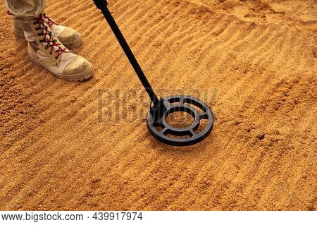 Mine Detector On The Background Of Feet And Sandy Soil. Training And Advanced Training Of Sappers. C