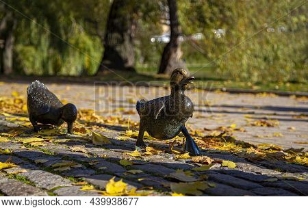 Monument To The Road Ducklings In The Park Novodevichy Ponds In Autumn--sculpture Of A Duck With Duc