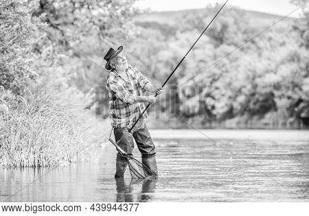 Fishing Is Fun. Mature Man Fly Fishing. Man Catching Fish. Summer Weekend. Big Game Fishing. Retired