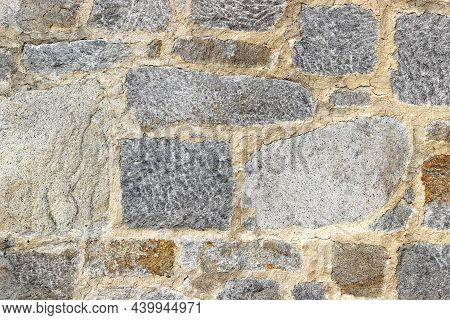 Wall Made Of Natural Rocks Of Different Sizes And Shapes As A Background