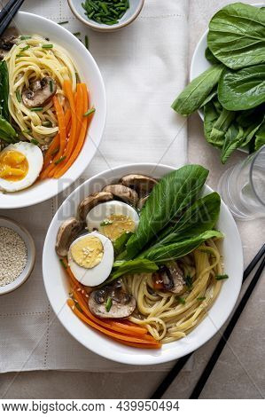 Two Bowls With Vegan Soup With Noodles, Vegetable Broth, Mushrooms, Eggs, Carrots. Top View, Assian 