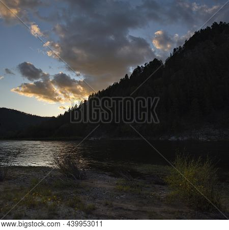 Russia. Chita Region. A Picturesque Sunset Sky With Flaming Clouds Over The Mountains Of The Menza R