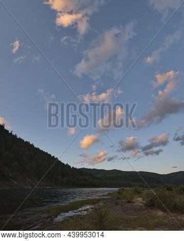 Russia. Chita Region. A Picturesque Sunset Sky With Flaming Clouds Over The Mountains Of The Menza R