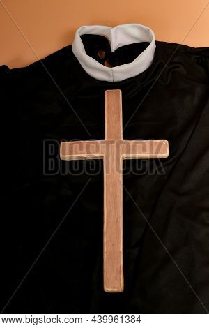 A Catholic Cross Lies On A Priest's Clothing Before A Church Service.