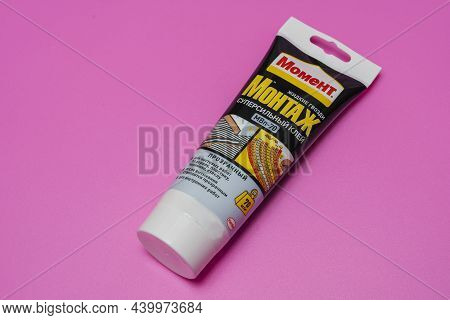 Sosnoviy Bor, Russia - November 15, 2021: Glue Liquid Nails Moment In A Tube On A Pink Background.