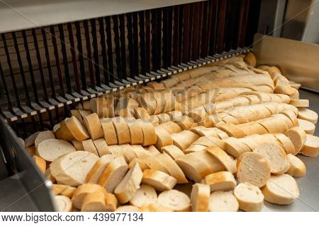 Bread Slicing Machine. Sliced Bread On The Production Line Of Food And Bakery Products. One Of The S