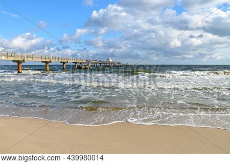Seabridge And Waves At The Beach In The Tourist Resort Zinnowitz At The Baltic Sea In Germany, Windy