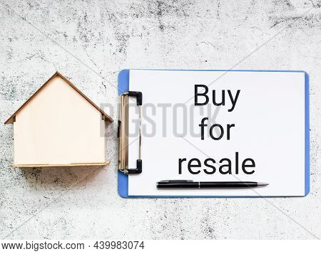 Mortgage Business Concept. Buy For Resale Written On Paper Clipboard With House Miniature.