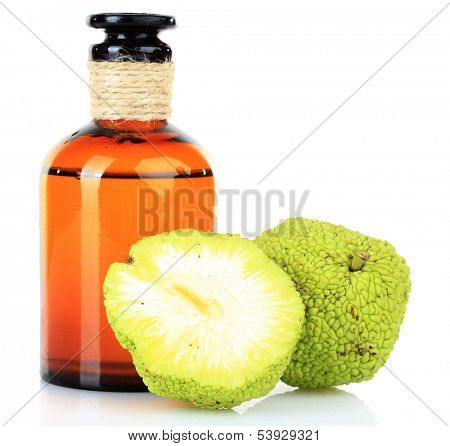Osage Orange fruits (Maclura pomifera) and medicine bottle, isolated on white