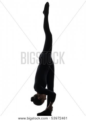 one caucasian woman contortionist practicing gymnastic yoga  in silhouette   on white background