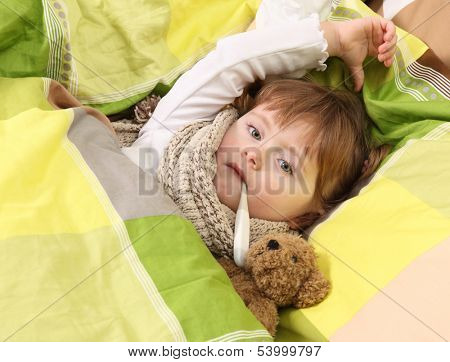  Little girl lying sick in bed