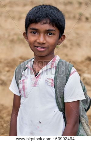 ELLA, SRI LANKA - MARCH 2, 2014: Portrait of local boy posing on tea plantation. Ella is famous for the tea plantations and stunning views across the countryside.
