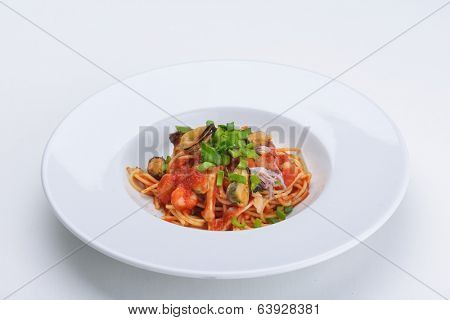 Pasta with shrimps, herbs and mashrooms isolated on white background in studio