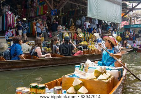 RATCHABURI, THAILAND - MARCH 24: Local peoples sell fruits, food and souvenirs at famous tourist attraction Damnoen Saduak floating market on March 24, 2014 in Ratchaburi, Thailand.