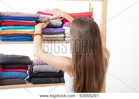 Young caucasian woman standing near the wardrobe