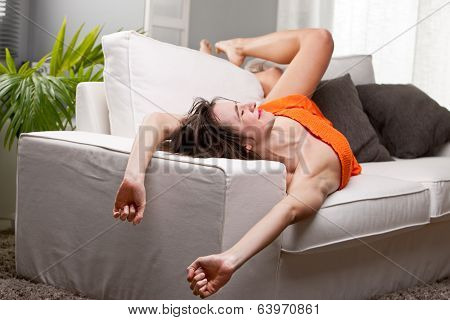 Girl Yawning And Stretching On Her Sofa