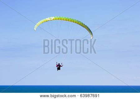 Paraglider flying above Mediterranean
