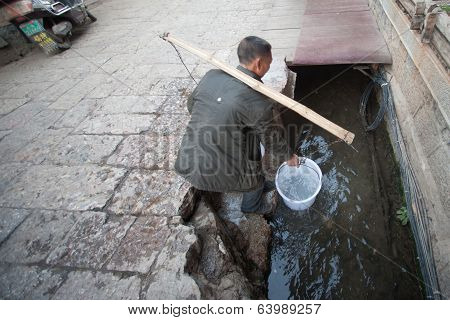 Chinese Naxi Male Used To Draw Water In Lijiang Old Town.