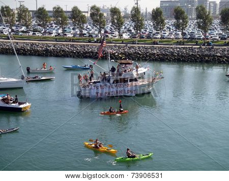 Mccovey Cove Fill With Kayaks, Boats, And People Having Fun, One Boat Featuring A Sign That Says 'it