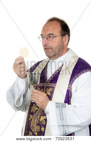 a catholic priest with chalice and host at communion