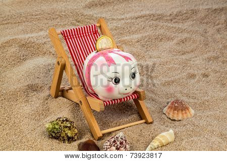 beach chair with euro currency on the sandy beach. symbol photo for costs in travel, vacation, holidays. save on vacation