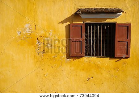 opened-window on yellow wall