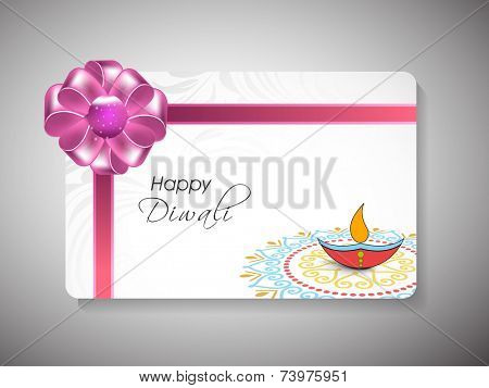 Happy Diwali gift card with illuminated oil lit lamp and ribbon decoration on floral decorated background.