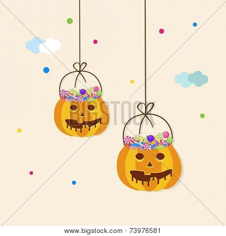 Halloween party celebration concept with hanging basket in pumpkin shape and full of lollipops.