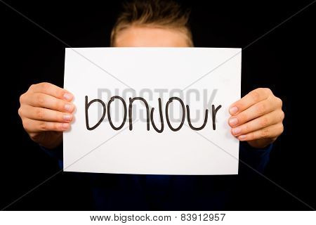 Child Holding Sign With French Word Bonjour - Hello