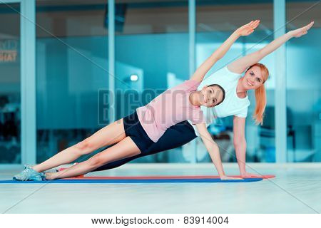 Mother and teenage girl at sports club