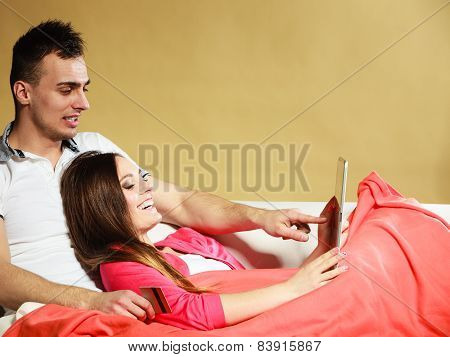 Young Couple With Tablet And Credit Card At Home