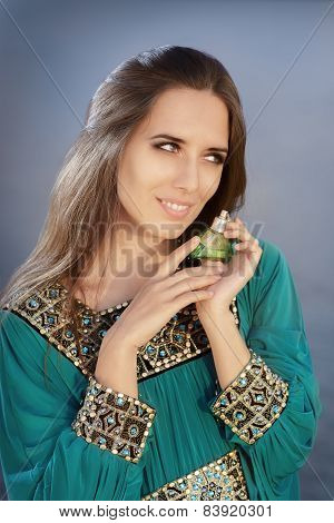 Young Woman Holding Perfume Bottle in Seaside Landscape