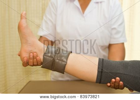 Rehab muscle training for leg with physical therapist