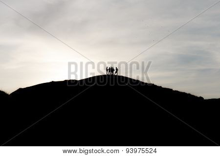 Silhouettes Of Tourists On Mountains