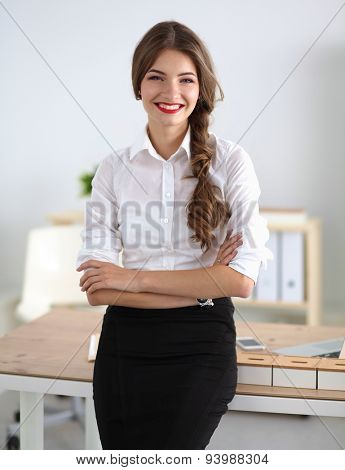 Attractive businesswoman with her arms crossed stnding