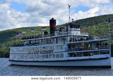 LAKE GEORGE, NY - SEP 24: Cruises around Lake George in New York State, as seen on Sep 24, 2016. The lake lies within the upper region of the Great Appalachian Valley and drains all the way northward into Lake Champlain and the St. Lawrence River drainage