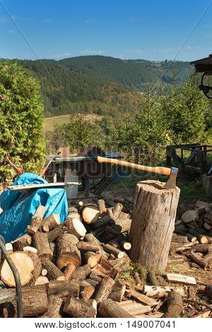 Old ax on log and firewood. Axe Cut into Wood after Chopping Firewood.