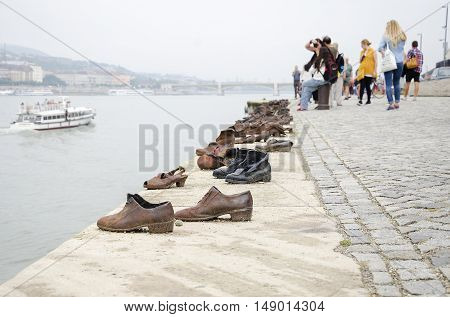 BUDAPEST, HUNGARY - SEPTEMBER 17: Shoes on the Danube Promenade - a monument to victims of the Holocaust, on September 17, 2016 in Budapest, Hungary.