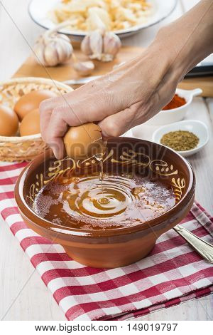 Chef Cracking An Egg On A Garlic Soup