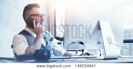 Closeup Bearded Businessman Wearing White Shirt Waistcoat Working Modern Loft Startup Desktop.Creative Young Man Use Smartphone Call Meeting Partner.Guy Work Office Thinking Business Strategy.Blurred